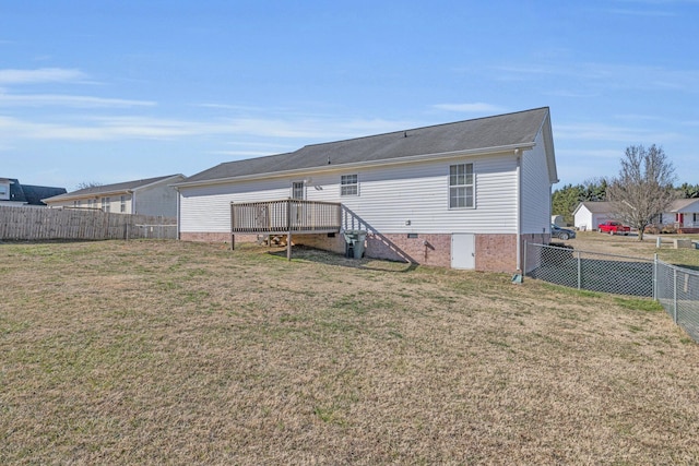 back of property featuring a lawn and a wooden deck