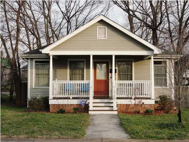 bungalow-style house with covered porch and a front yard