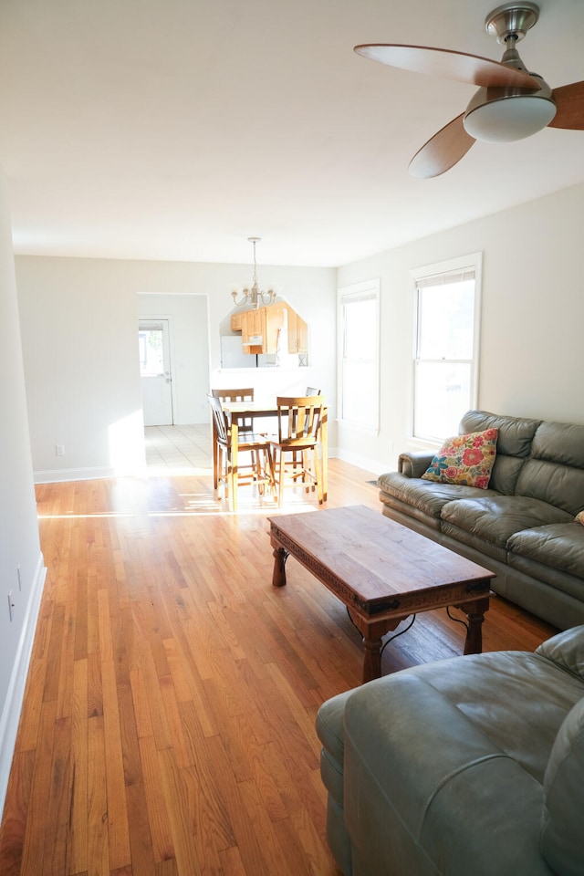 living room with light hardwood / wood-style floors and ceiling fan