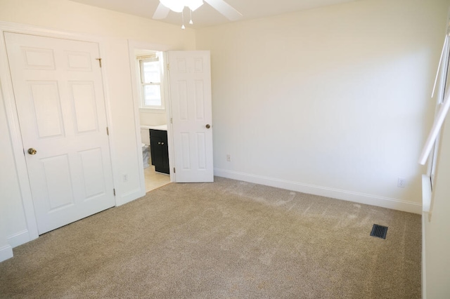 unfurnished bedroom with ceiling fan and light carpet