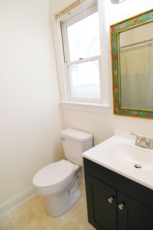 bathroom with toilet and vanity