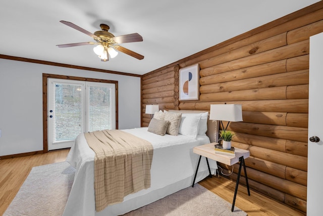 bedroom with log walls, ornamental molding, access to outside, ceiling fan, and light wood-type flooring