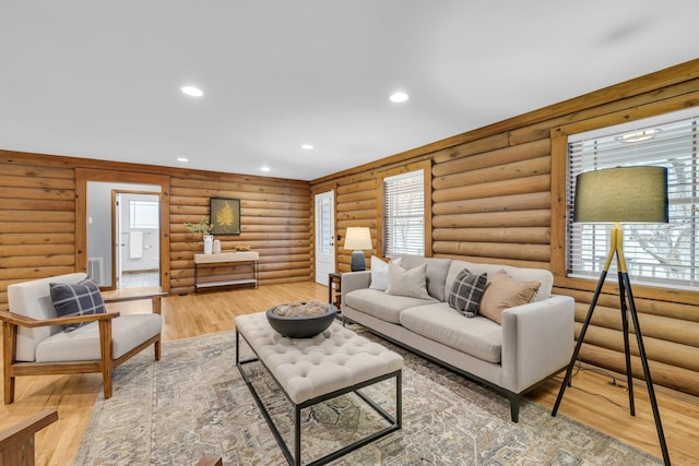 living room featuring hardwood / wood-style floors and rustic walls