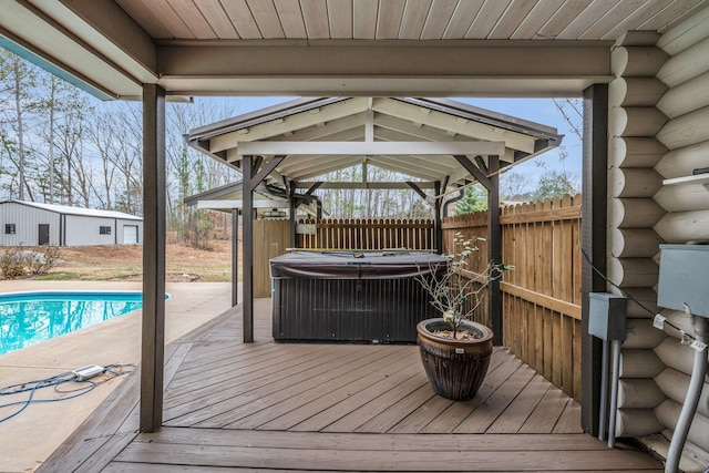 wooden terrace with a gazebo and a pool with hot tub