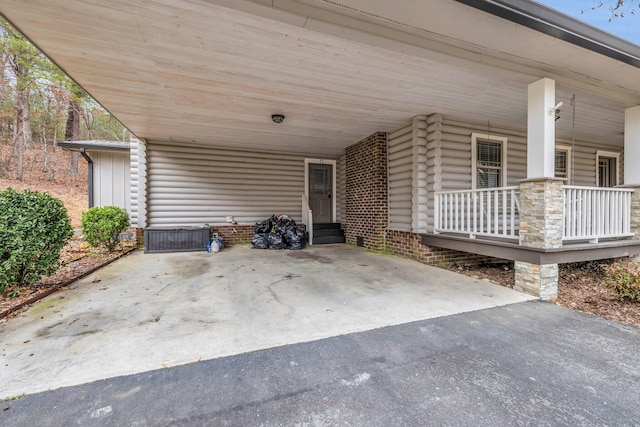 view of patio / terrace with a carport and a porch