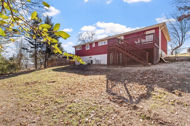 rear view of property featuring a wooden deck