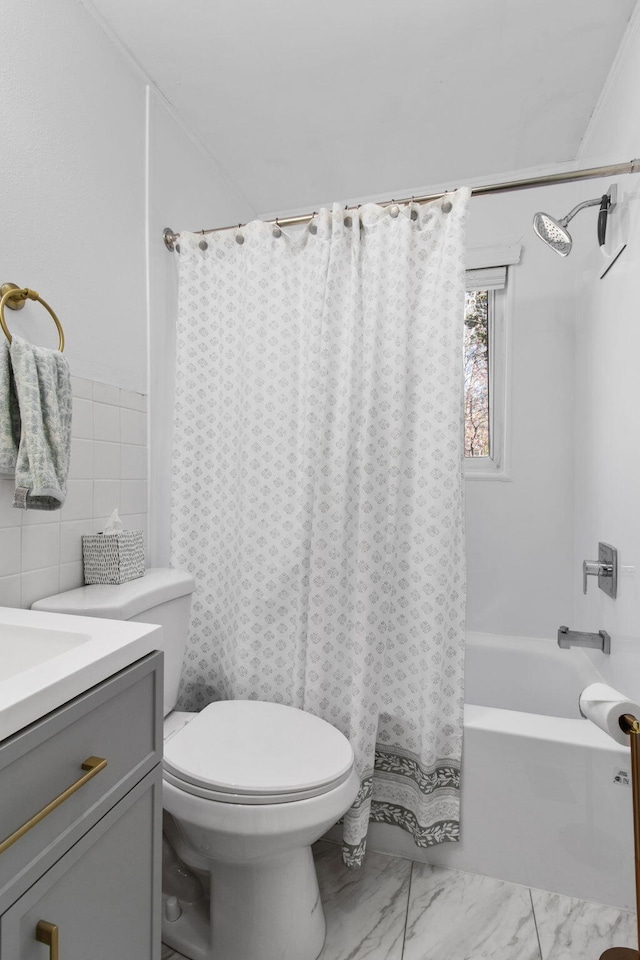 full bathroom with vanity, tile walls, shower / tub combo with curtain, and toilet