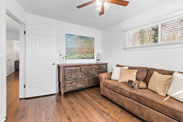 living room featuring dark hardwood / wood-style flooring and ceiling fan