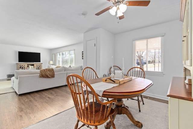 dining space featuring ceiling fan and wood-type flooring