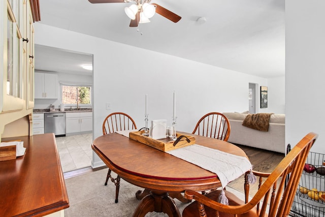 dining space with sink and ceiling fan