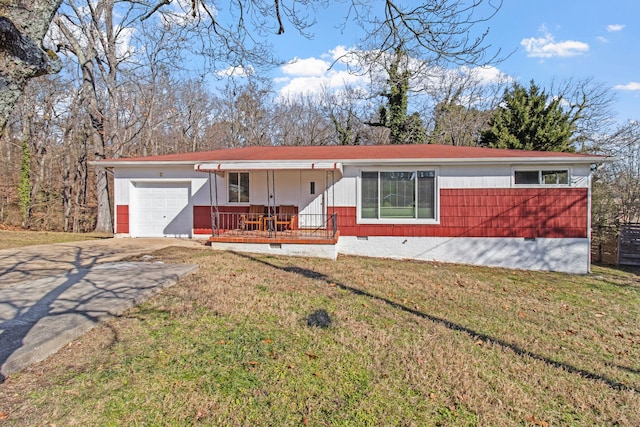 view of front facade featuring a garage, covered porch, and a front lawn