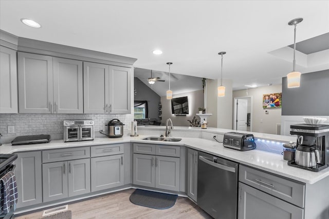 kitchen with sink, hanging light fixtures, stainless steel dishwasher, and gray cabinets