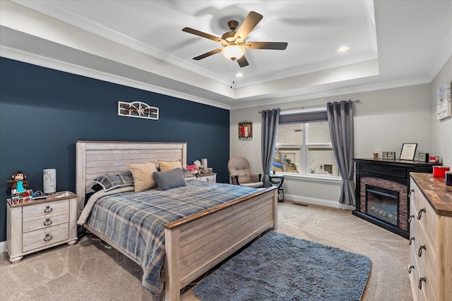 bedroom featuring ceiling fan, a raised ceiling, ornamental molding, and light carpet