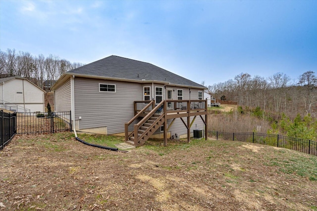 rear view of property with central AC unit and a wooden deck