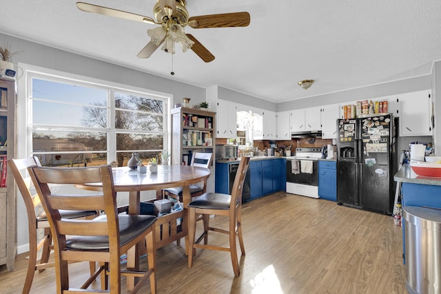 dining room with ceiling fan and light wood-type flooring