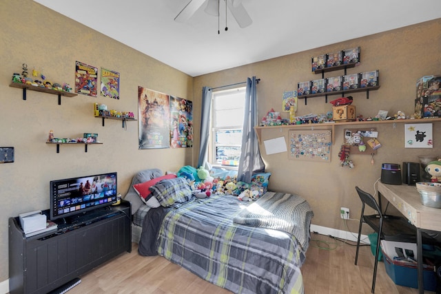 bedroom featuring light hardwood / wood-style floors and ceiling fan