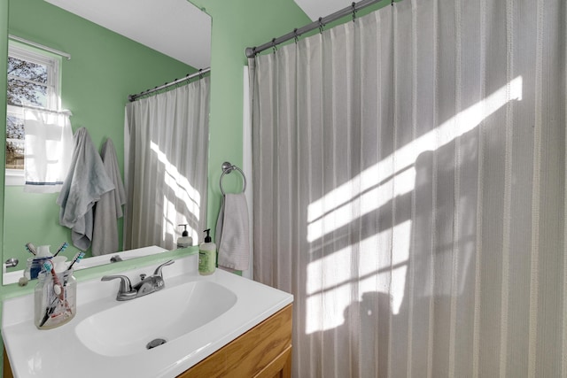 bathroom featuring vanity and a shower with shower curtain