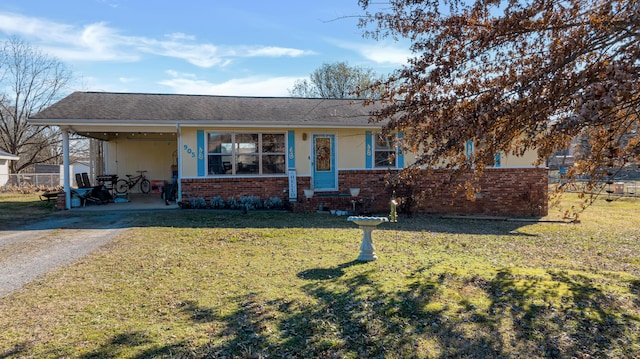 view of front of house with a carport and a front lawn