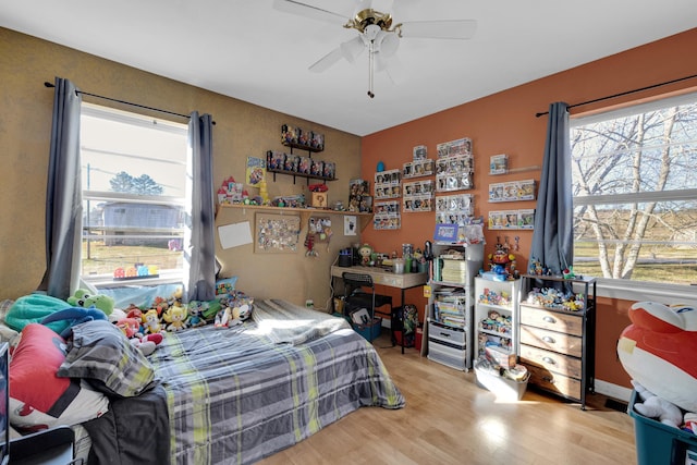 bedroom with ceiling fan and light hardwood / wood-style flooring