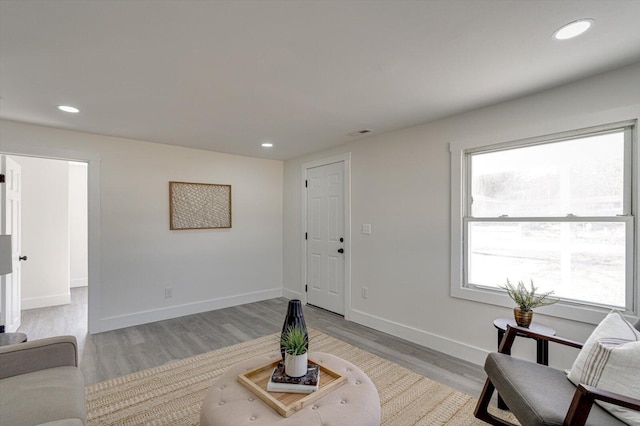 living area with plenty of natural light and light hardwood / wood-style floors