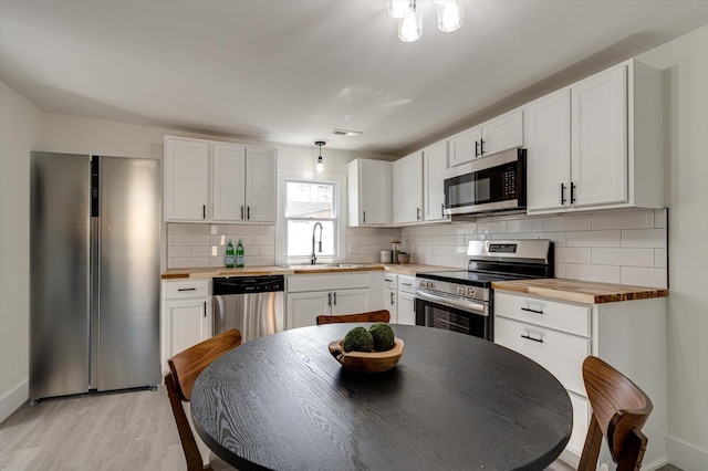 kitchen with white cabinetry, appliances with stainless steel finishes, and sink