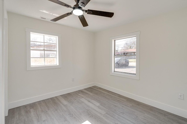 empty room featuring ceiling fan and light hardwood / wood-style flooring