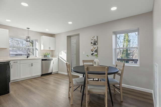 dining room with sink and light wood-type flooring