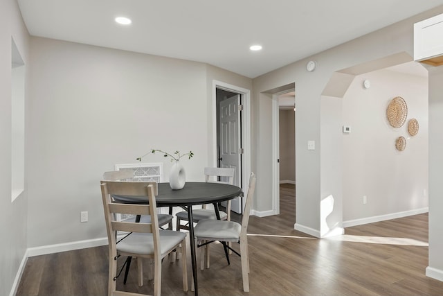 dining space featuring wood-type flooring