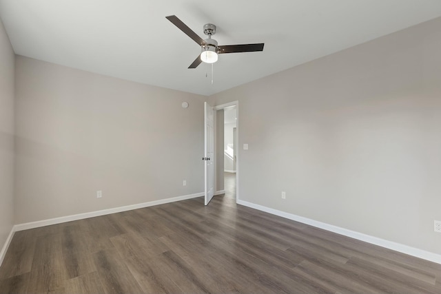 empty room featuring ceiling fan and dark hardwood / wood-style floors