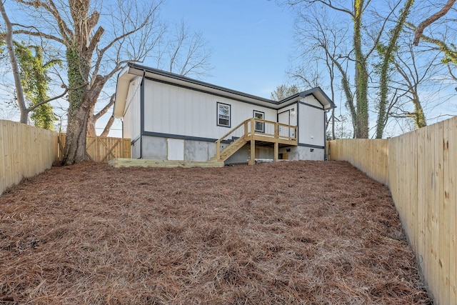 back of house featuring a deck