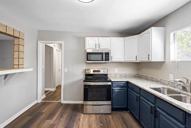 kitchen featuring white cabinets, stainless steel appliances, blue cabinetry, and sink