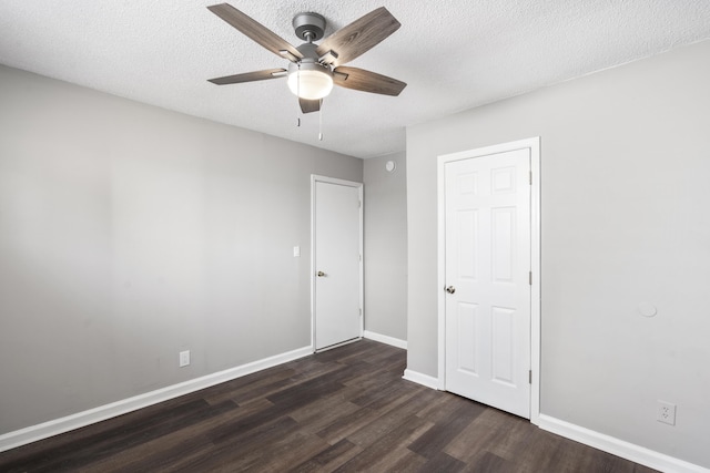 unfurnished bedroom with ceiling fan, dark hardwood / wood-style floors, and a textured ceiling