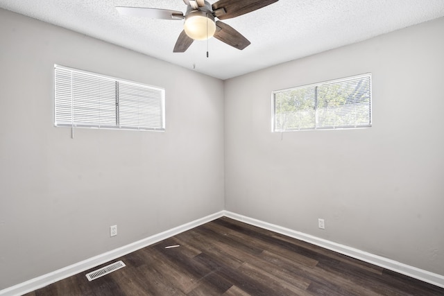 unfurnished room featuring ceiling fan, dark hardwood / wood-style flooring, and a textured ceiling