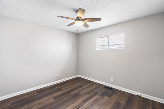 spare room with a textured ceiling, ceiling fan, and dark hardwood / wood-style flooring