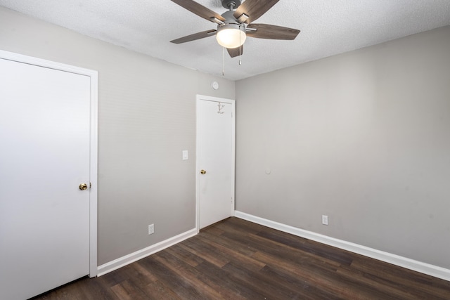 interior space featuring ceiling fan, dark hardwood / wood-style flooring, and a textured ceiling