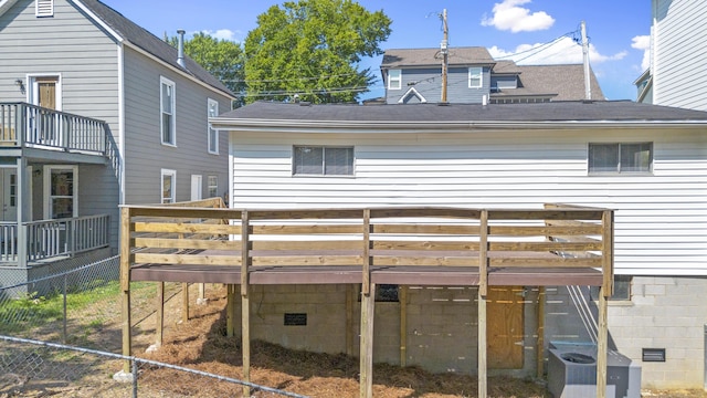 rear view of house with a wooden deck and cooling unit