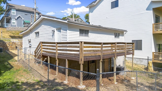 rear view of property with central air condition unit and a wooden deck