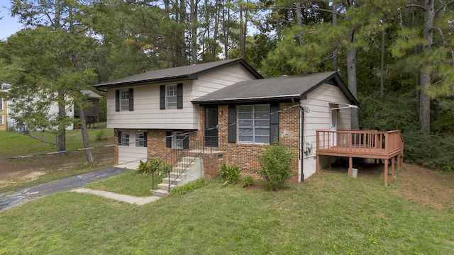 split level home with a wooden deck and a front lawn