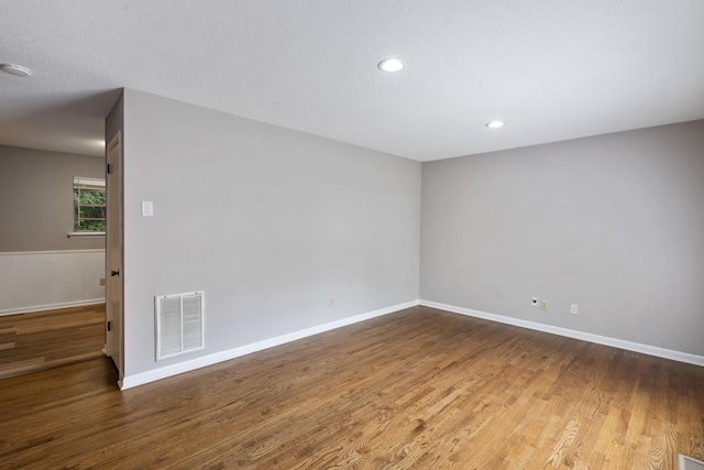 spare room featuring wood-type flooring