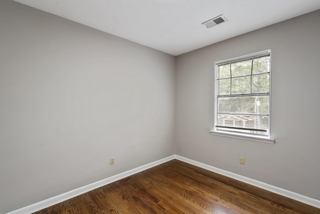 unfurnished room featuring dark hardwood / wood-style floors