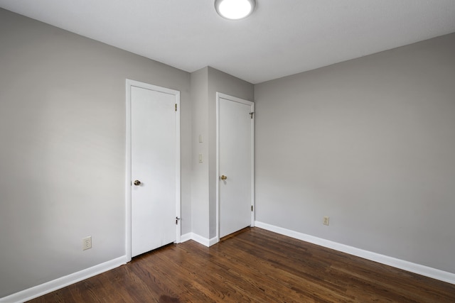 unfurnished bedroom with dark hardwood / wood-style floors