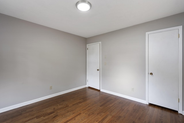 spare room featuring dark hardwood / wood-style floors