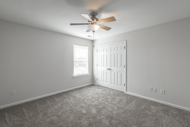 unfurnished bedroom featuring ceiling fan, carpet floors, and a closet