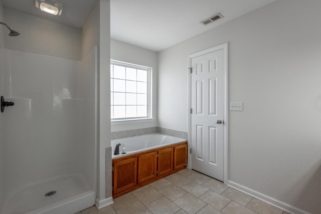 bathroom with tile patterned floors and plus walk in shower