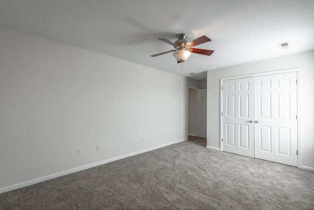 unfurnished bedroom with carpet, ceiling fan, and a closet