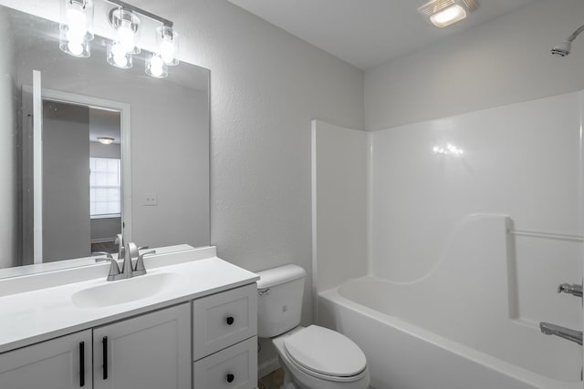 full bathroom with vanity, shower / washtub combination, and toilet