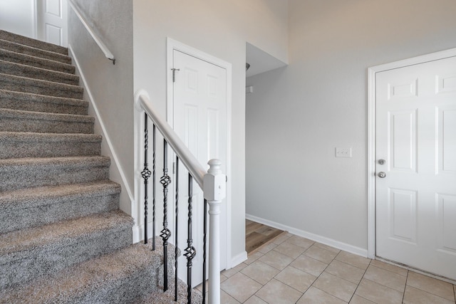 staircase featuring tile patterned flooring