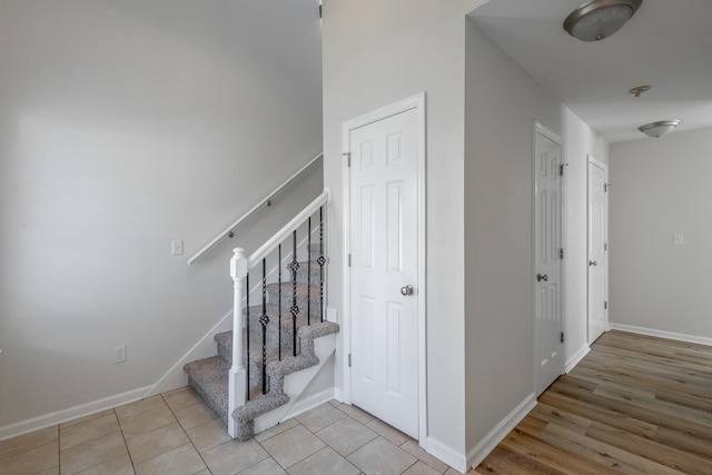 stairs featuring tile patterned flooring