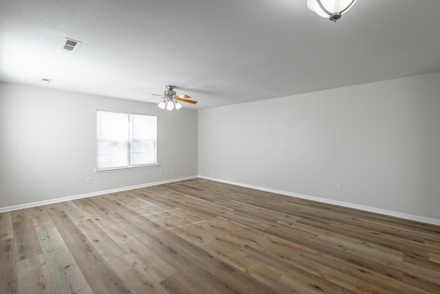 unfurnished room featuring light hardwood / wood-style floors and ceiling fan