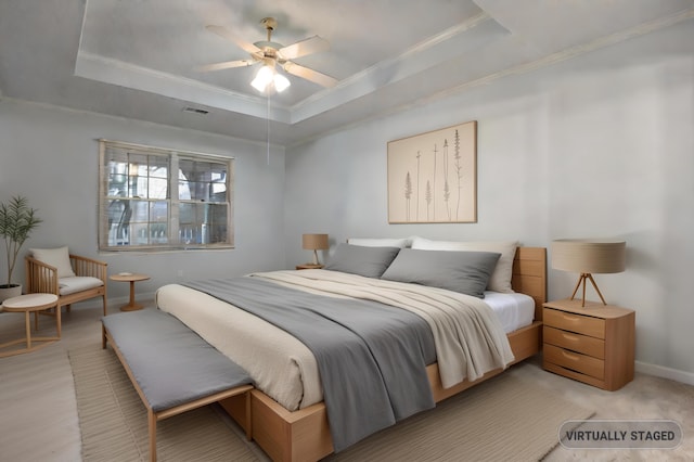 bedroom with a raised ceiling, crown molding, and ceiling fan